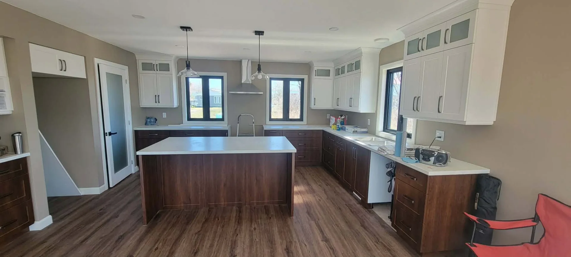 Completed bright kitchen with dark wood cabinetry